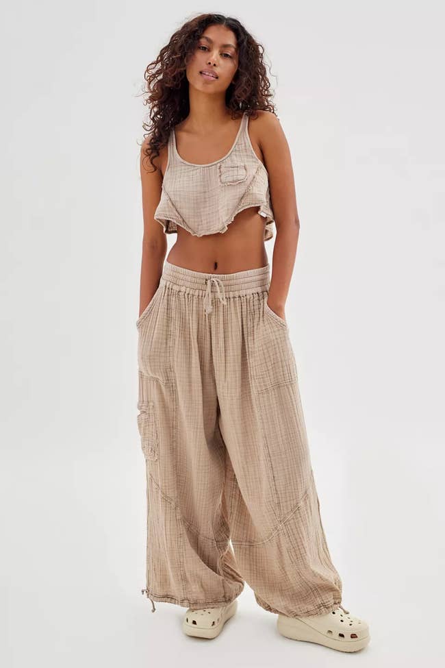 A model poses in the beige pants