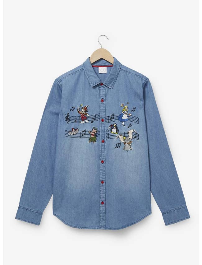 a denim long sleeve top with music notes and disney characters embroidered across the middle