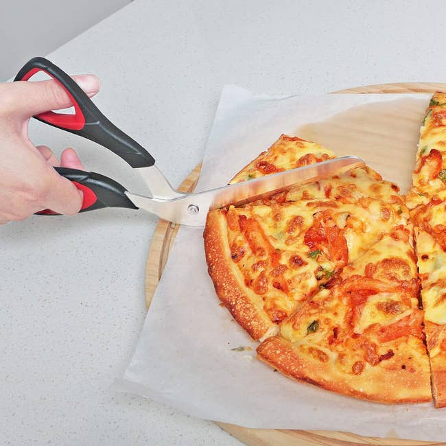 model using black pizza scissors