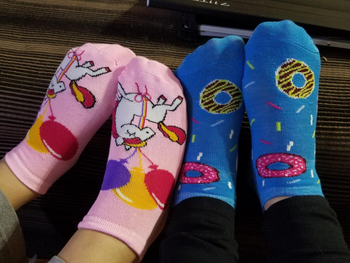 Reviewer image of two people wearing pink and blue socks