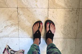 a reviewer wearing the sandals with wraps around the top and back of their foot