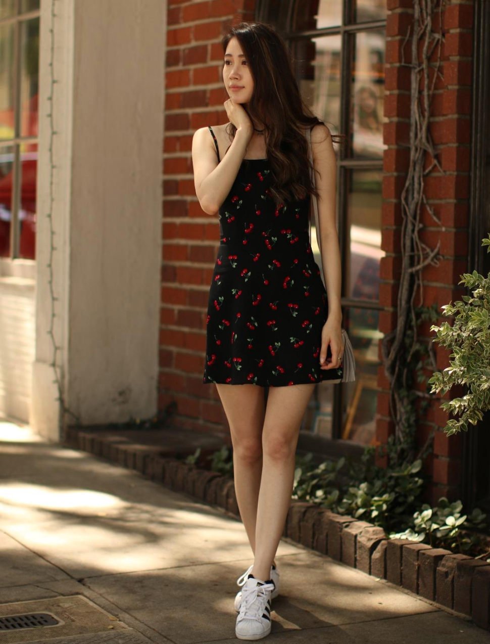 reviewer wearing the cherry print dress