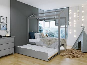 gray trundle canopy bed, with trundle rolled out