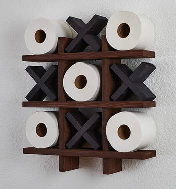the dark wood and black toilet paper holder