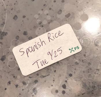 reviewer's container of spanish rice labeled with name and date on blank label