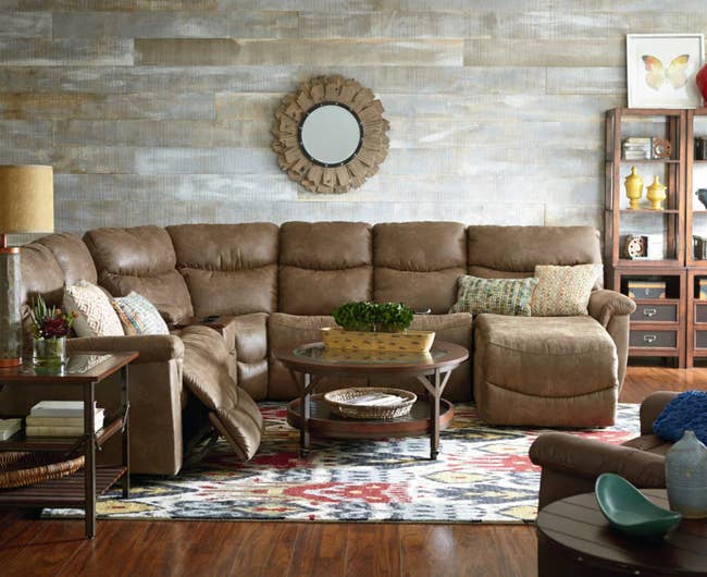 lifestyle photo of brown faux leather reclining sectional
