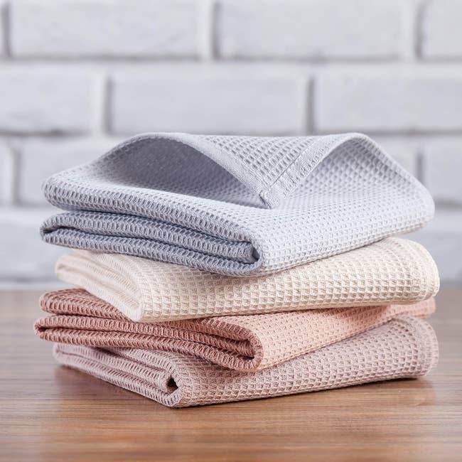 A stack of 4 textured room towels folded neatly