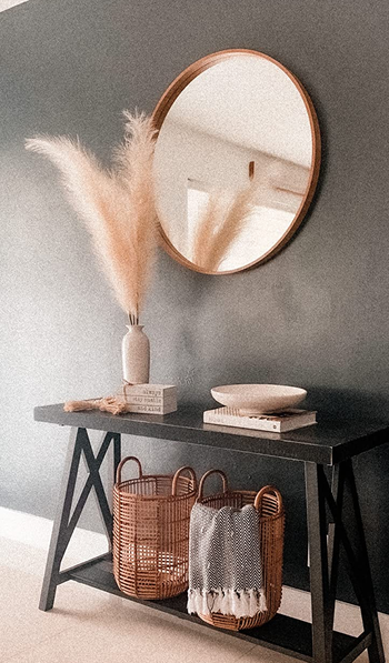 reviewer image of pampas grass styled in a vase next to a mirror