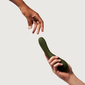 Hands reaching for green vibrator
