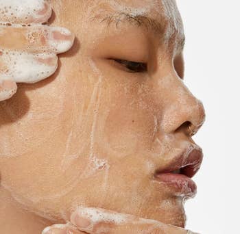 person using cleanser on skin