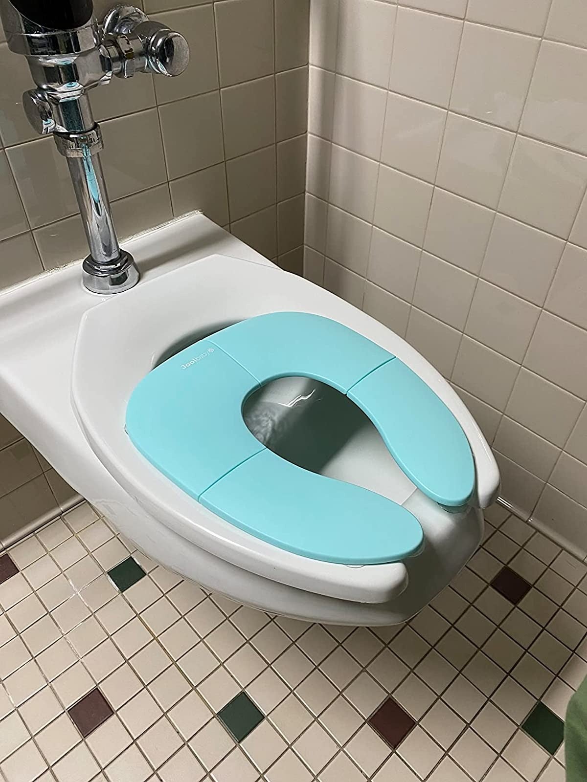 reviewer image of the blue portable potty seat on a public toilet