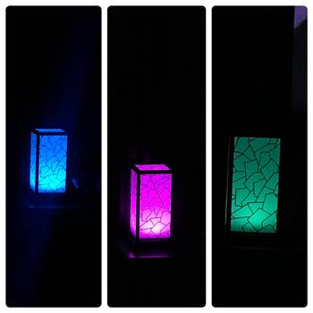 three lamps lit up in blue, purple, and green