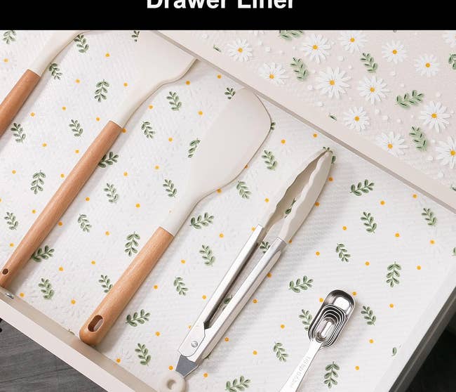 Patterned drawer liner in a kitchen drawer with utensils for a home organization article