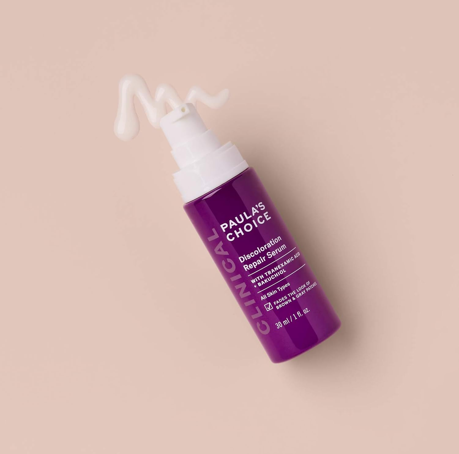 Purple bottle of Paula's Choice Discoloration Repair Serum with pump dispenser on a soft background