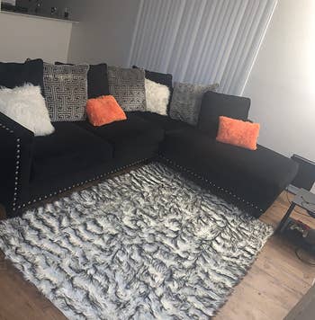 Reviewer image of white and gray rug under black couch
