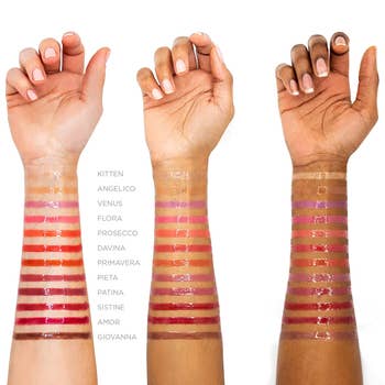 swatches of the lip glaze in 12 colors on three different skin tones 