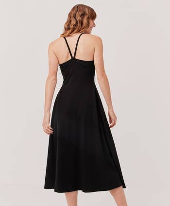 a back view of the model wearing the dress in black