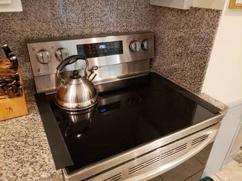 reviewer photo of black gap covers placed on each side of the stove