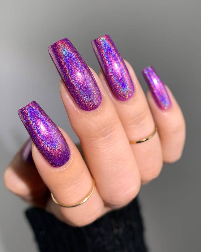 models hand with purple holographic nail polish