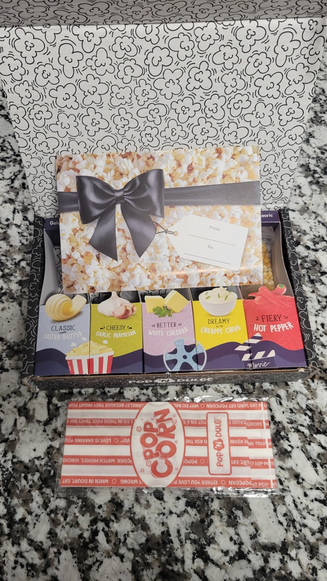 Gift container  with assorted popcorn flavors, including classic, cheesy, kettle, and blistery  pepper