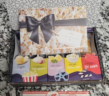 Gift container with assorted popcorn flavors, including classic, cheesy, kettle, and blistery pepper