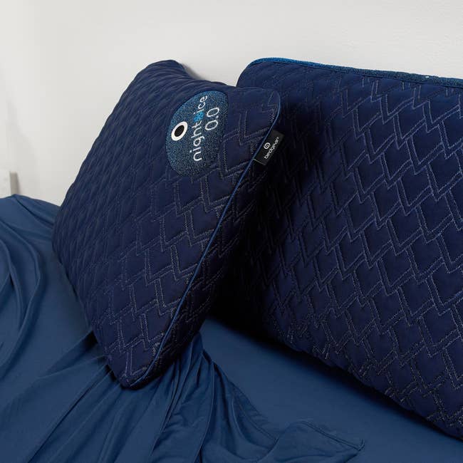 Pillow and mattress with patterned covers, showcasing comfortable, high-quality bedding suitable for a luxurious sleep experience