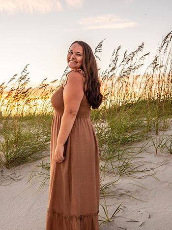 side view of reviewer wearing the brown dress