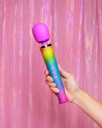 Model holding rainbow ombre wand vibrator