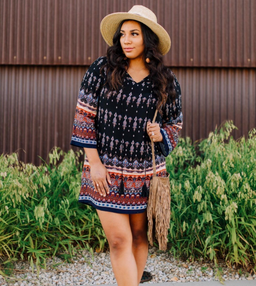 reviewer wearing long-sleeve midi in a boho-style print with bag and hat