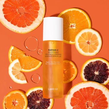 the product laying on a surface surrounded by citrus fruits