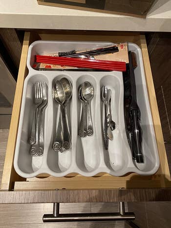 before photo of a silverware organizer that takes up the length and width of the entire drawer