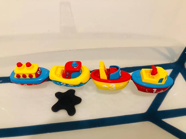 colorful magnetic boats in the tub