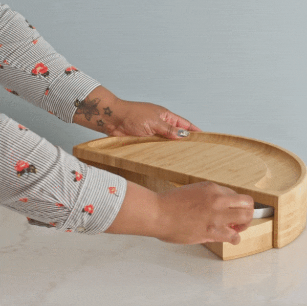 gif of model pulling out the swivel part of the board and the drawer with cheese knives