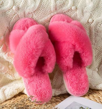 the pink slippers on a knit blanket