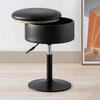 stool with height adjusting bar and storage seat lifted off 