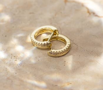 Product image of the gold plated huggie earrings