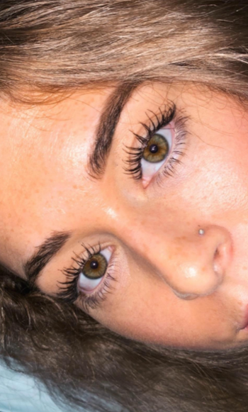closeup of reviewer's face with very long eyelashes 
