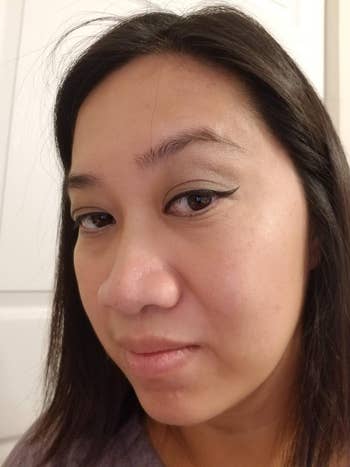 reviewer with cat eye liner applied with the stamp