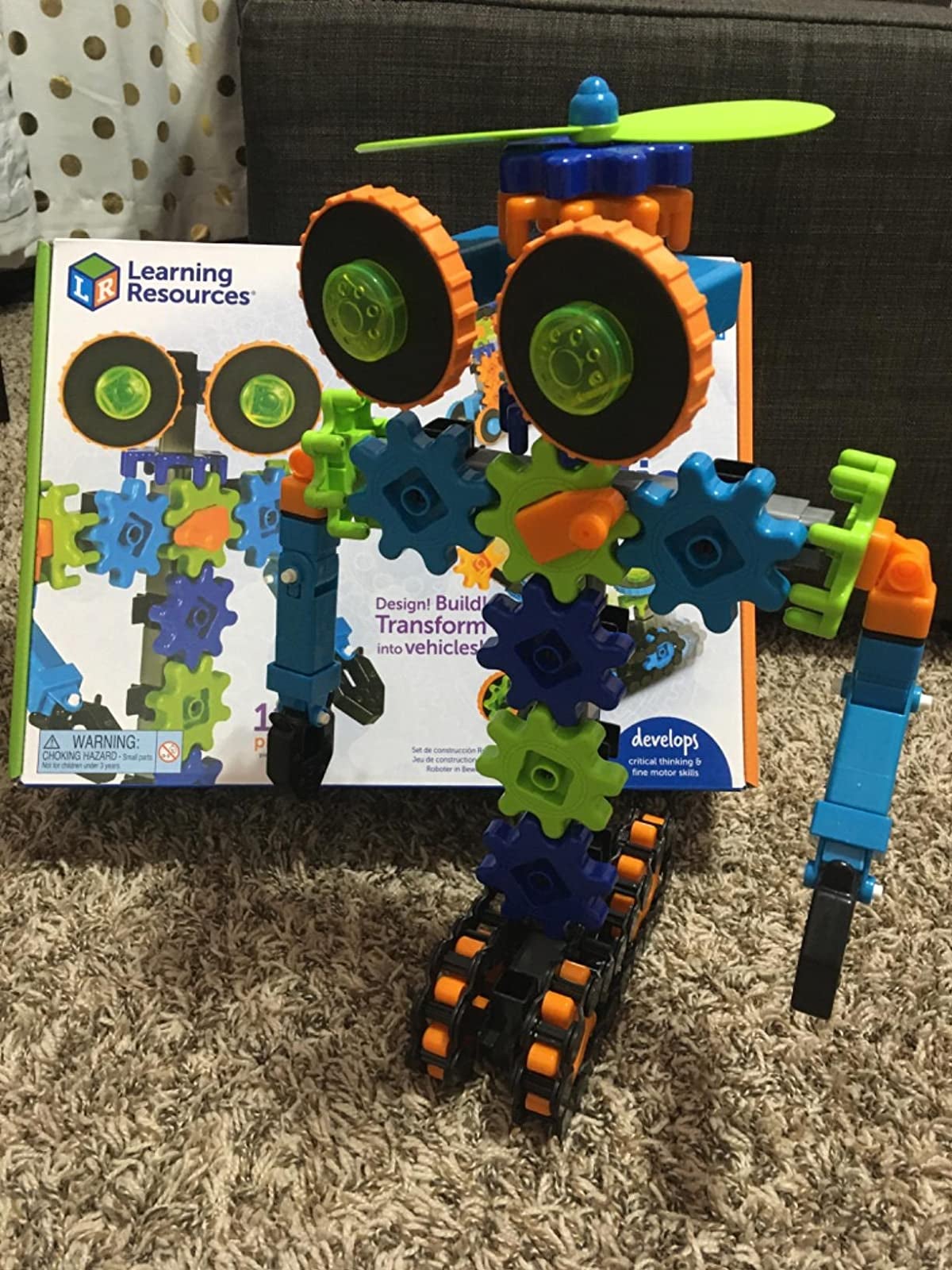 Reviewer's image of colorful plastic robot toy and packaging