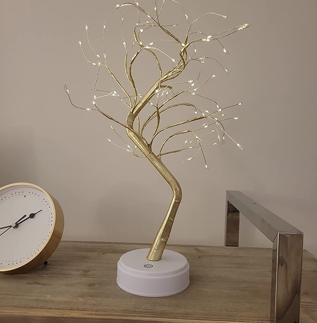 reviewer photo of the gold bonsai lamp on a table