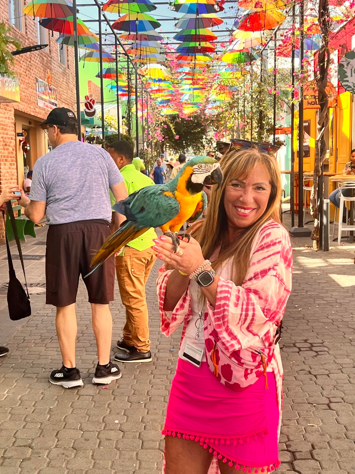 reviewer wearing the pink skirt on a busy street