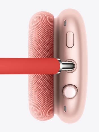 top view of the pink headphones which have two buttons for volume and noise cancellation