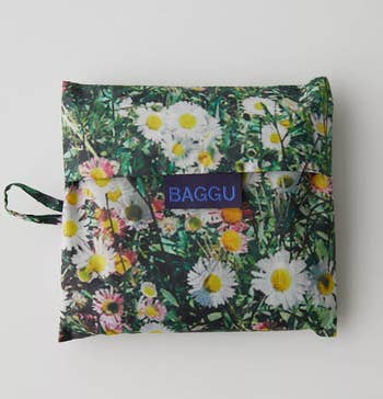 A floral patterned version of the bag folded into a tiny square 