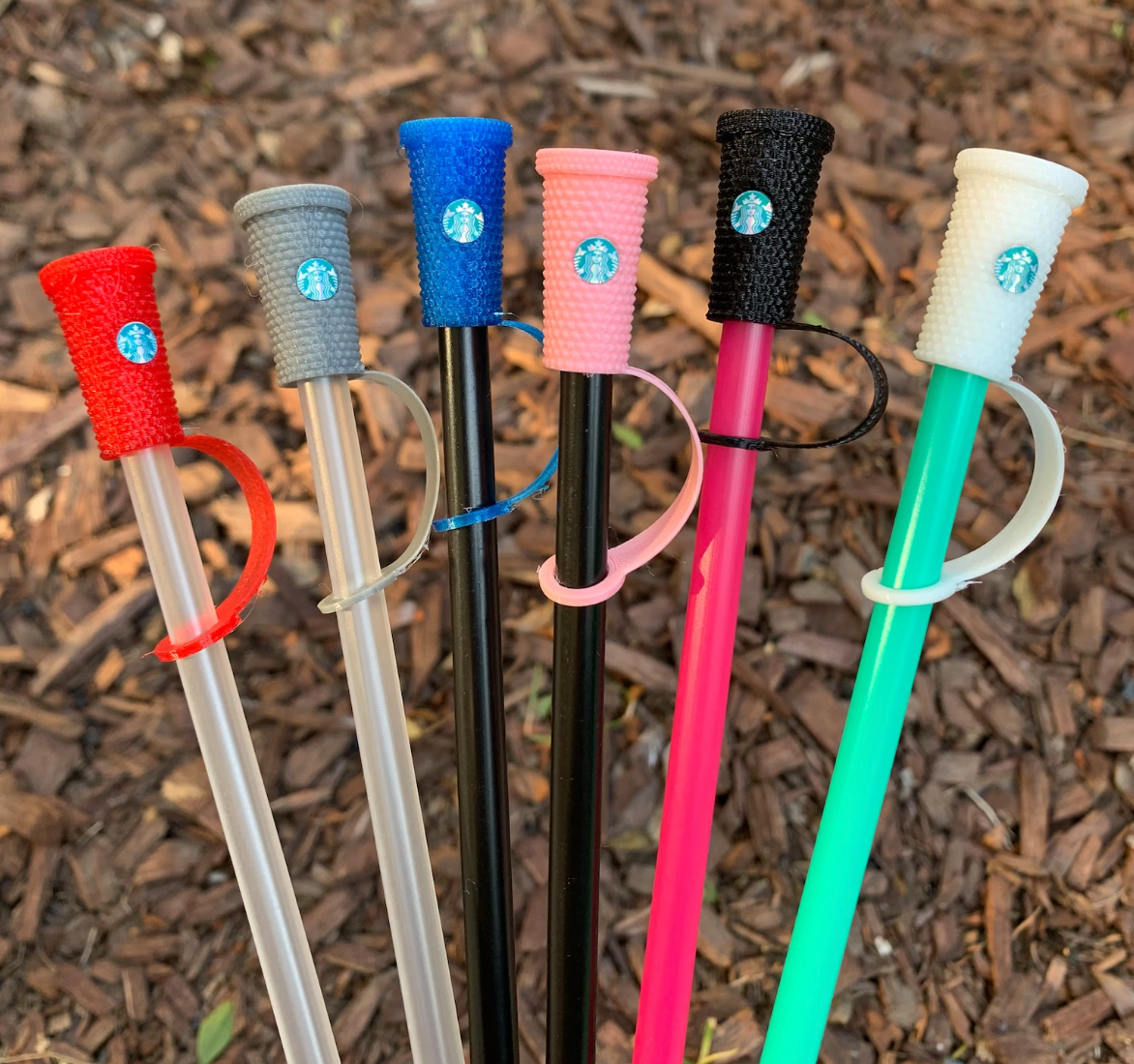 various straws with the starbucks cups inspired covers on them