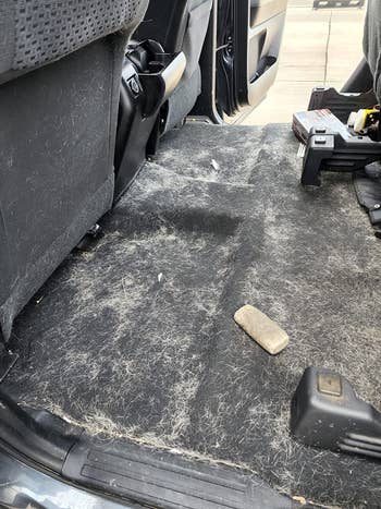 Car level  covered successful  favored  hairsbreadth  and dirt; cleaning supplies disposable   successful  the background, indicating mentation  for interior cleaning