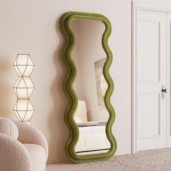 Full-length mirror with a wavy green frame