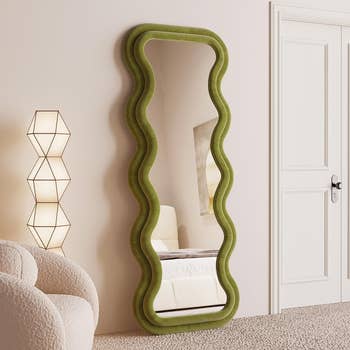 Full-length mirror with a wavy green frame