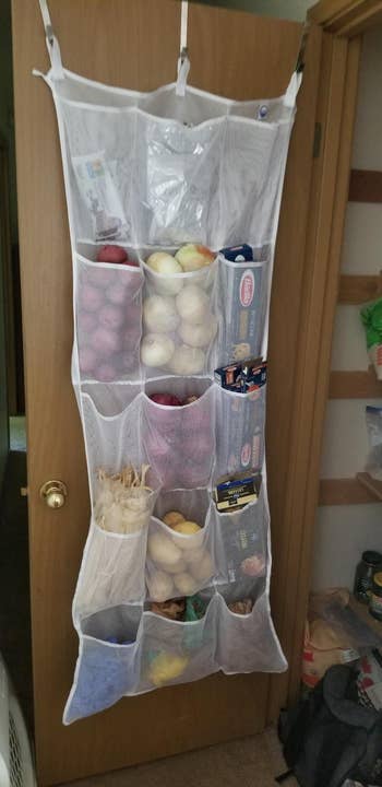 a reviewer's organizer hanging in their pantry organizing a bunch of foods
