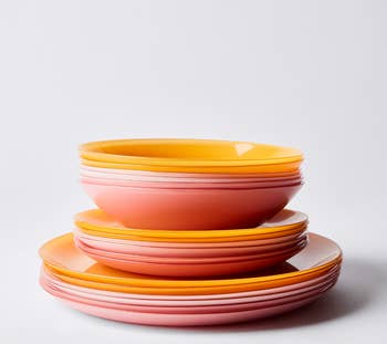 Plates of varying colors and sizes stacked on top of each other