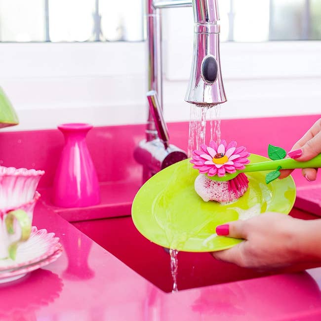 a dish scrubbing brush that looks like a pink flower